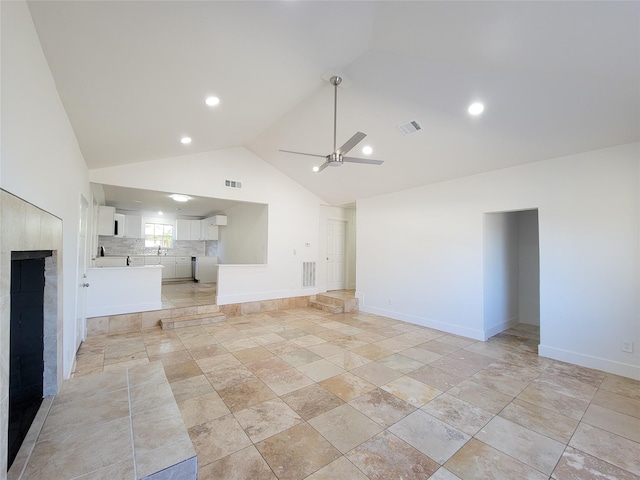 unfurnished living room featuring high vaulted ceiling, ceiling fan, visible vents, and baseboards