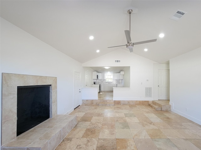 unfurnished living room featuring vaulted ceiling, visible vents, and a ceiling fan