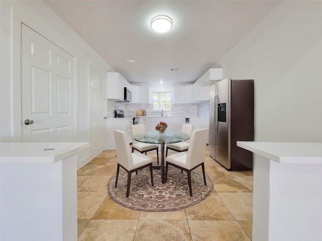 dining room featuring visible vents