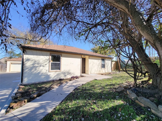 single story home featuring fence, a front lawn, and stucco siding