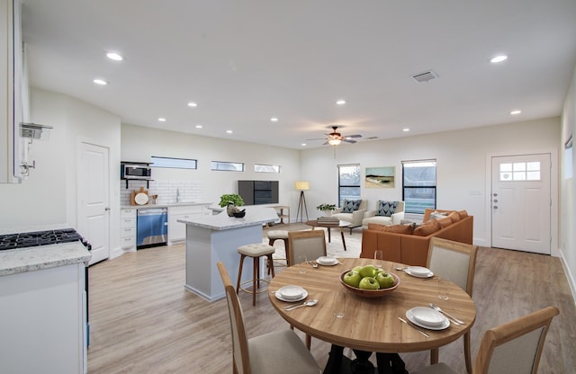 dining room with a ceiling fan, recessed lighting, visible vents, and light wood finished floors