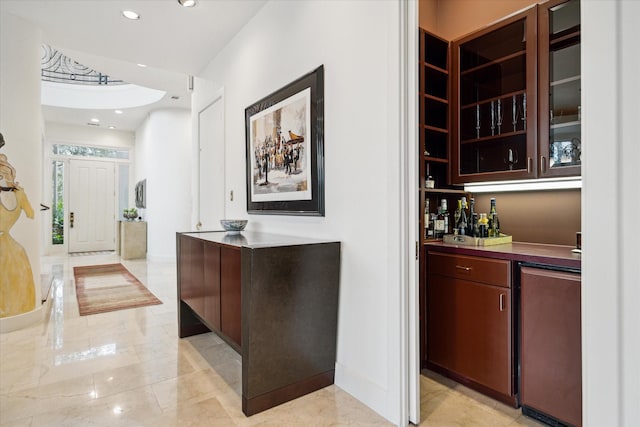 bar with fridge, baseboards, marble finish floor, and recessed lighting