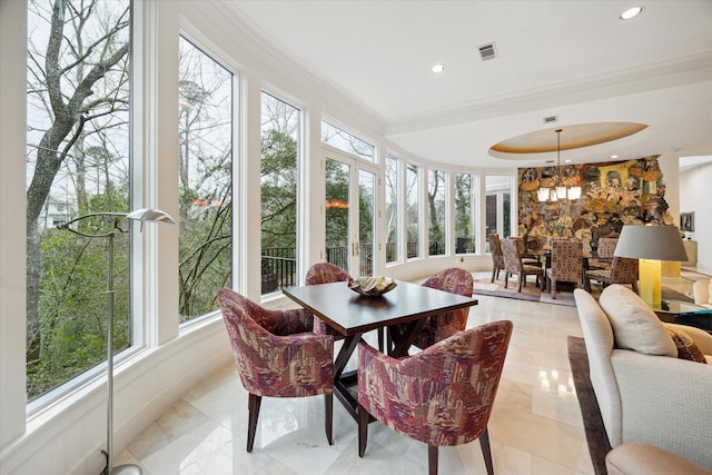 sunroom featuring a healthy amount of sunlight, an inviting chandelier, visible vents, and a tray ceiling