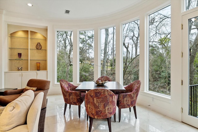 sunroom / solarium with a healthy amount of sunlight and visible vents