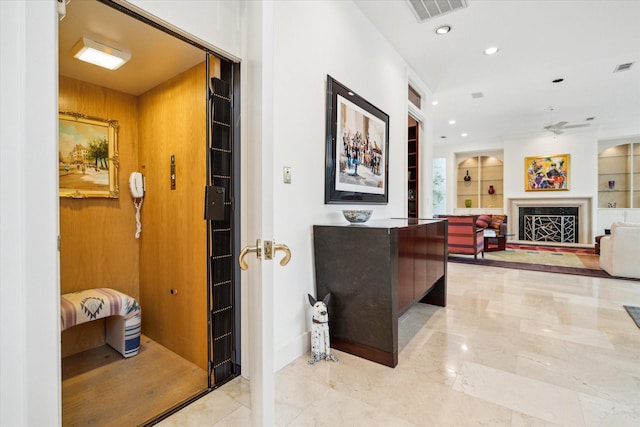 hallway featuring recessed lighting, visible vents, and built in features