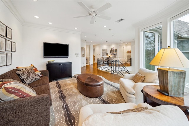 living area featuring crown molding, recessed lighting, visible vents, a ceiling fan, and wood finished floors