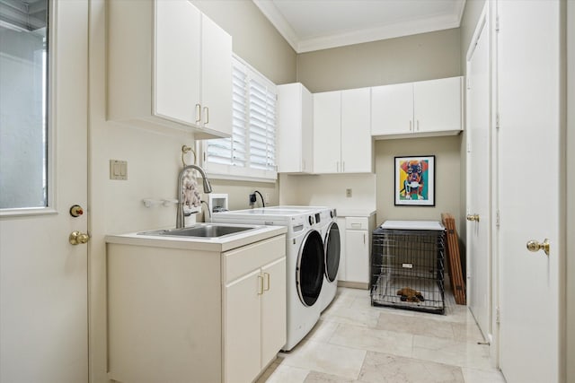 washroom with marble finish floor, crown molding, cabinet space, a sink, and separate washer and dryer