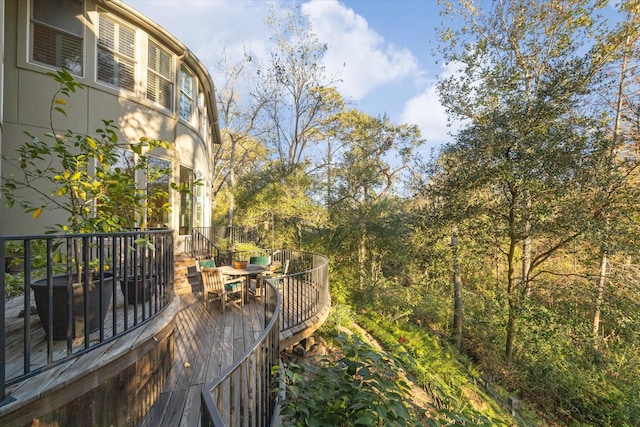 surrounding community featuring a deck and outdoor dining area