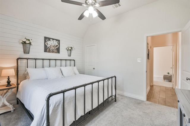 bedroom with lofted ceiling, ceiling fan, light colored carpet, visible vents, and baseboards