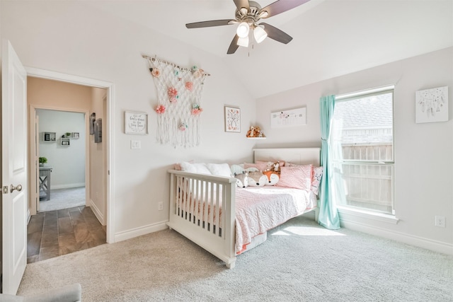 bedroom featuring carpet floors, baseboards, vaulted ceiling, and a ceiling fan