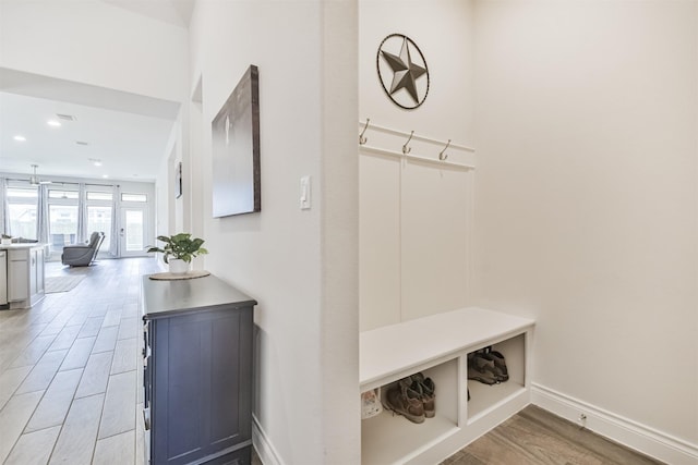 mudroom with light wood-style floors, baseboards, and recessed lighting