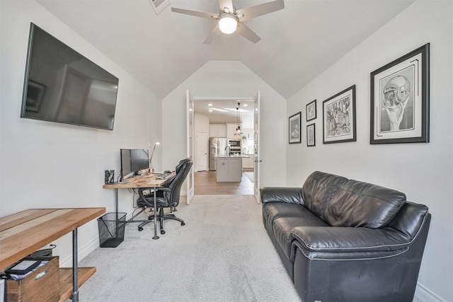 home office featuring visible vents, light carpet, vaulted ceiling, ceiling fan, and baseboards