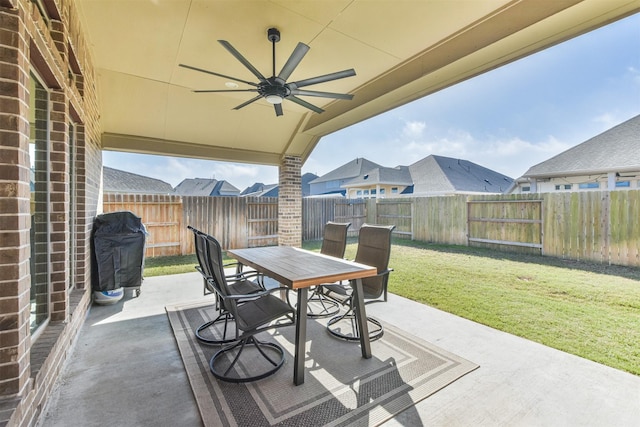 view of patio / terrace featuring a fenced backyard, a grill, a ceiling fan, and outdoor dining space