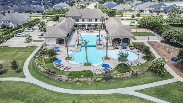 pool featuring a patio area and a residential view