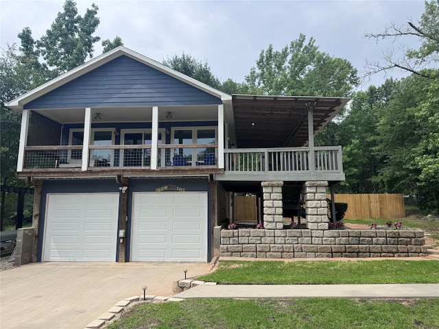 view of front of home with concrete driveway, an attached garage, and a balcony