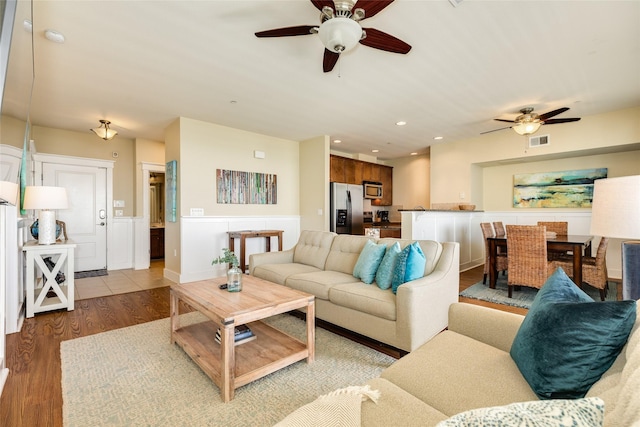 living area featuring ceiling fan, recessed lighting, visible vents, and light wood-style floors