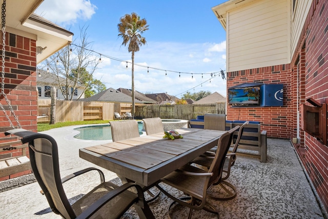 view of patio / terrace featuring outdoor dining area, a fenced backyard, and a fenced in pool