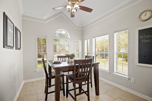 dining space featuring lofted ceiling, baseboards, crown molding, and light tile patterned flooring