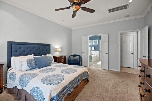 carpeted bedroom with ceiling fan, connected bathroom, visible vents, baseboards, and ornamental molding