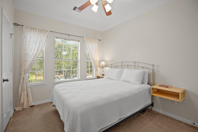 bedroom featuring ceiling fan, carpet, visible vents, and baseboards