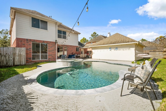 view of pool featuring a patio, a fenced backyard, and a pool with connected hot tub