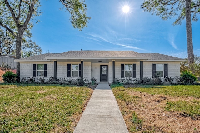 ranch-style house with brick siding and a front lawn