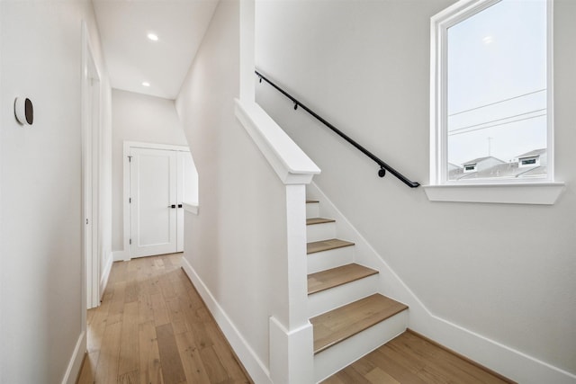 stairs featuring recessed lighting, wood finished floors, and baseboards