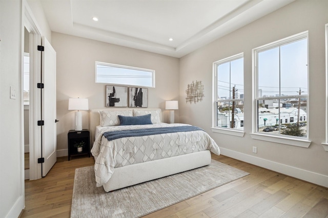 bedroom featuring recessed lighting, light wood finished floors, and baseboards