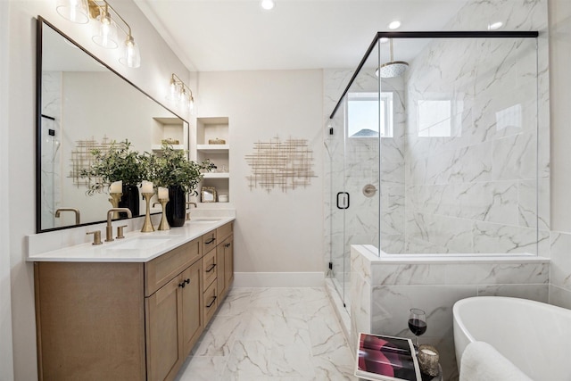full bathroom featuring a freestanding tub, marble finish floor, a marble finish shower, and a sink