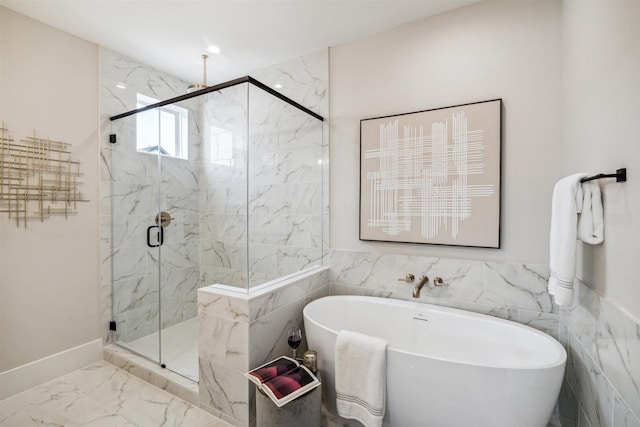 full bathroom with a freestanding bath, marble finish floor, and a marble finish shower