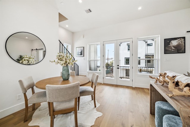 dining room with stairway, visible vents, french doors, baseboards, and light wood-style flooring