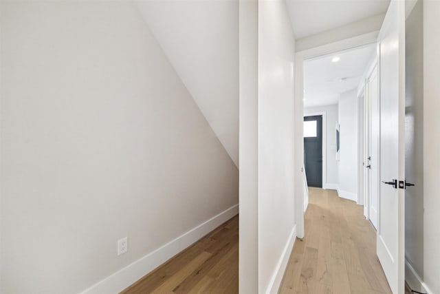 hall featuring recessed lighting, baseboards, and light wood-type flooring