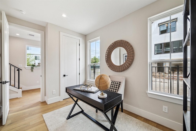 office area with baseboards, light wood-style floors, and recessed lighting
