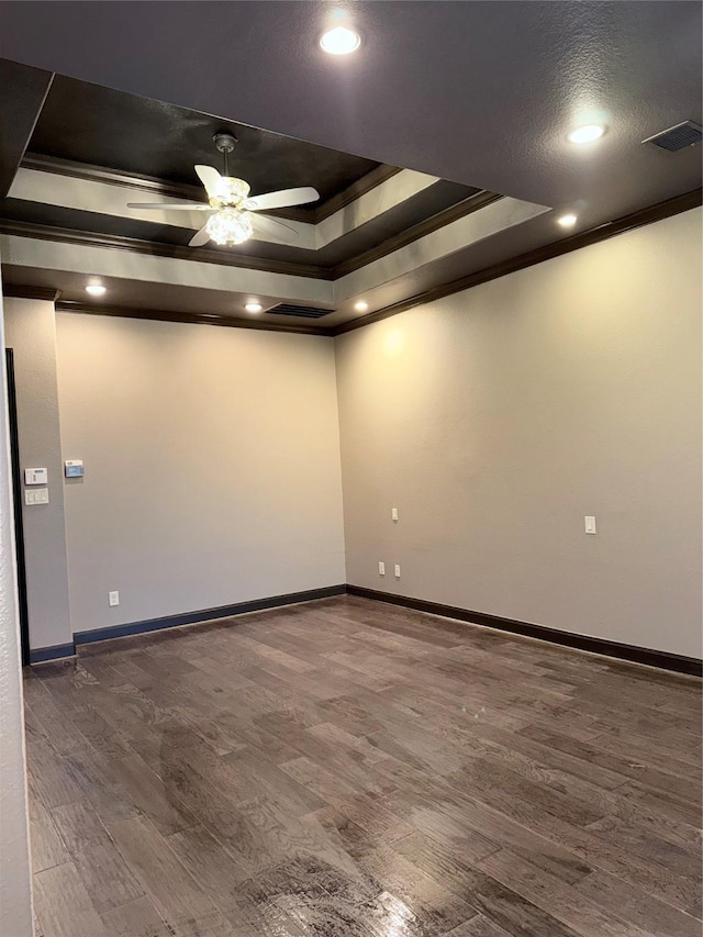 18931 Winding Atwood Ln, Tomball, TX 77377 - empty room featuring dark wood-type flooring, a raised ceiling, and visible vents