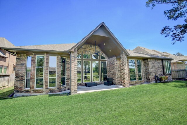 18931 Winding Atwood Ln, Tomball, TX 77377 - back of house with brick siding, a lawn, a patio area, and fence
