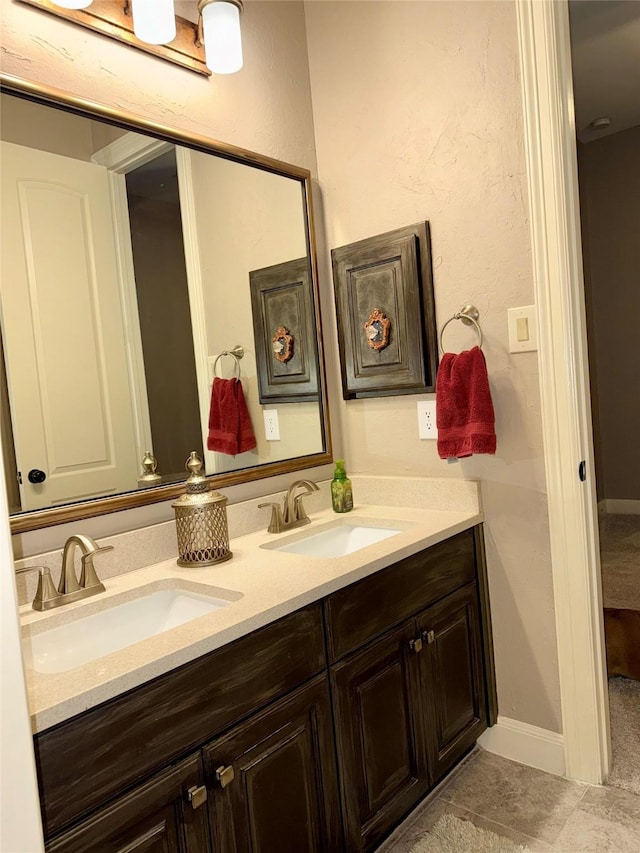 18931 Winding Atwood Ln, Tomball, TX 77377 - bathroom with double vanity, tile patterned floors, a sink, and baseboards