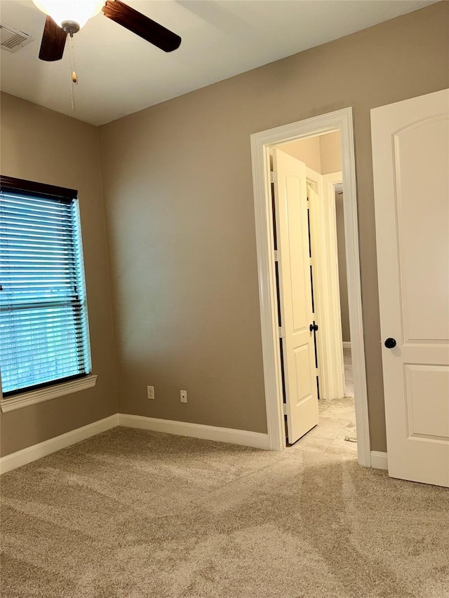 18931 Winding Atwood Ln, Tomball, TX 77377 - spare room featuring light colored carpet, visible vents, ceiling fan, and baseboards
