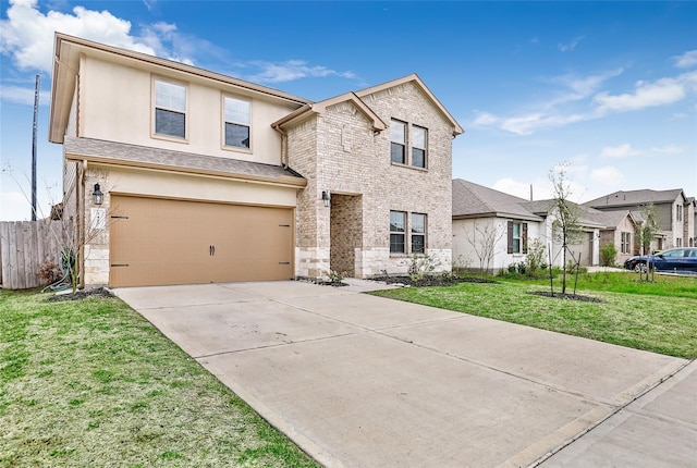 traditional home with concrete driveway, an attached garage, fence, a front lawn, and stucco siding