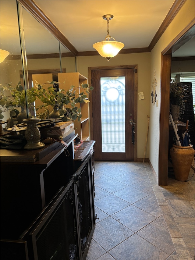 entrance foyer with baseboards, ornamental molding, and stone finish flooring