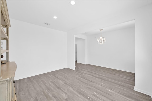 interior space with baseboards, wood finished floors, visible vents, and recessed lighting