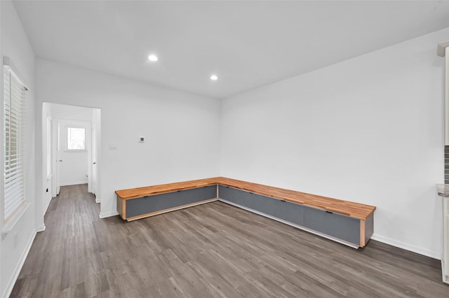 unfurnished room featuring baseboards, wood finished floors, and recessed lighting