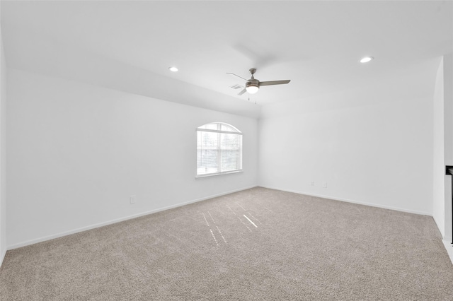 carpeted spare room with recessed lighting, ceiling fan, and baseboards