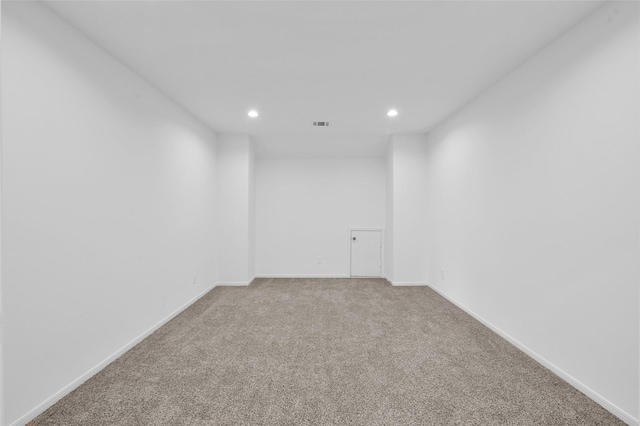 carpeted empty room featuring baseboards and recessed lighting