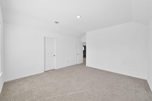 unfurnished room with recessed lighting, carpet floors, visible vents, baseboards, and vaulted ceiling