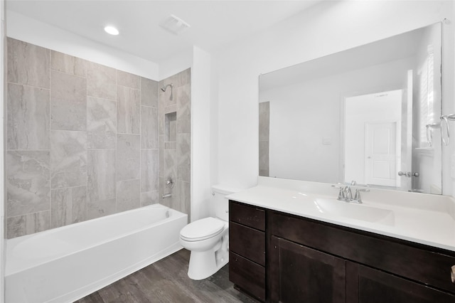 full bathroom with bathing tub / shower combination, visible vents, toilet, vanity, and wood finished floors