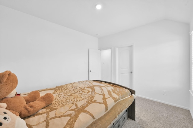 bedroom with light carpet and baseboards