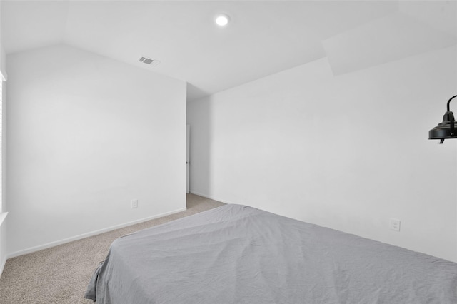 carpeted bedroom with lofted ceiling, visible vents, baseboards, and recessed lighting