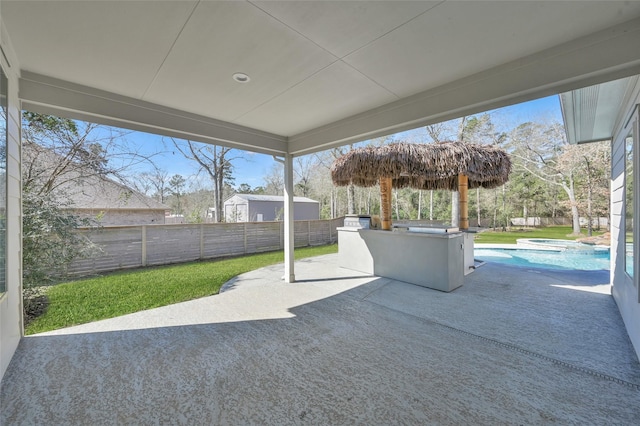 view of patio / terrace featuring a fenced backyard, a fenced in pool, and an in ground hot tub