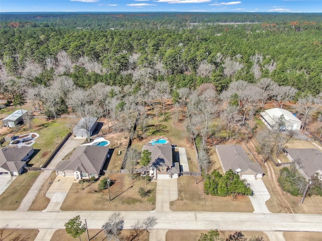 bird's eye view featuring a wooded view