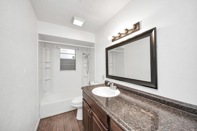 bathroom with toilet, shower / washtub combination, wood finished floors, and vanity